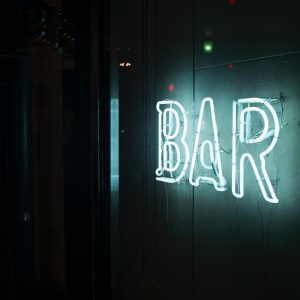 photo of turn-on white bar neon sign by Alex Knight